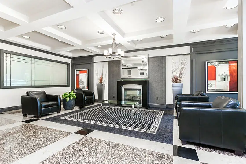 Contemporary Living Room Design With Black Leather Armchairs With Modern Fireplace And Polished Granite Floors