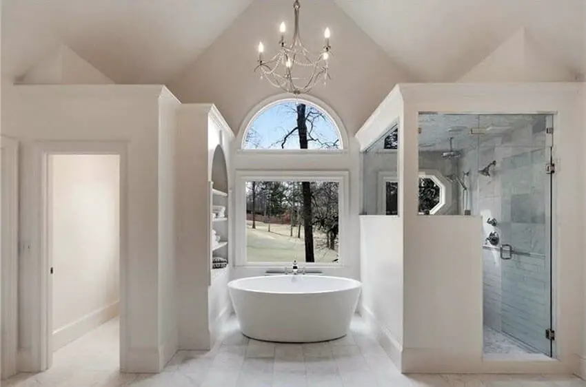 Beautiful white marble modern bathroom with chandelier and high ceilings