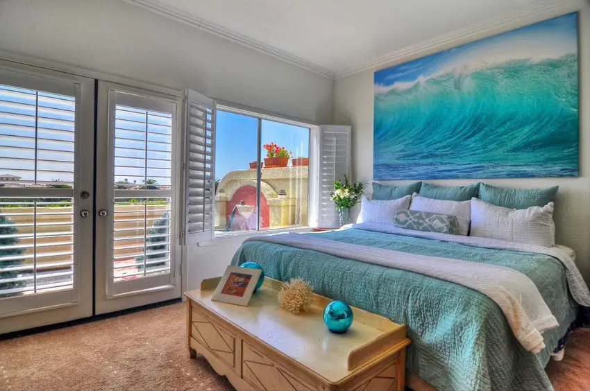 Bedroom with Ocean Wall Art Teal Bed Covers and White Plantation Shutters