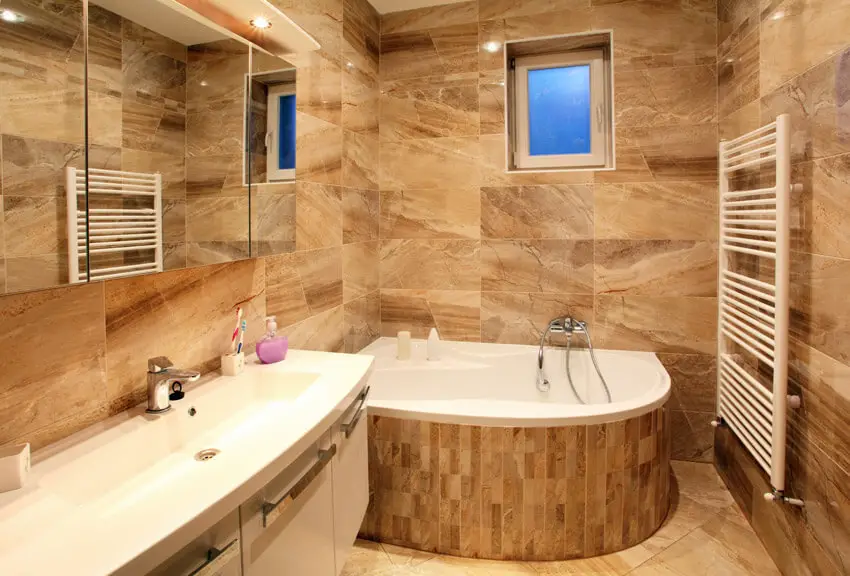 bathroom in luxury home with bath and furniture