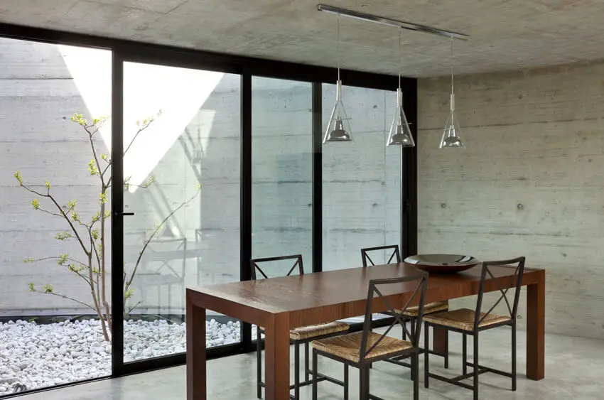 concrete dining room with wood table