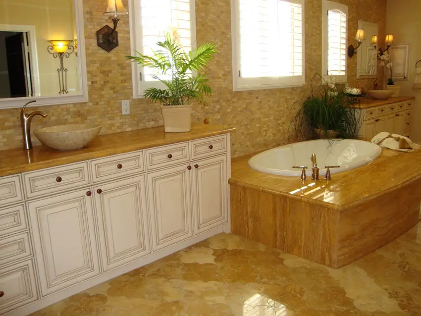 elegant luxury bathroom with white cabinet tan tile