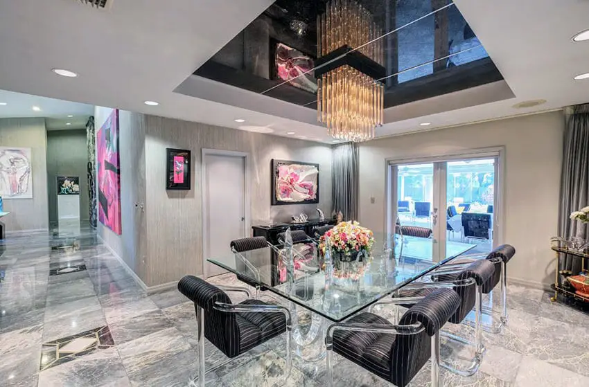 glam modern dining room with marble floors and tray ceiling