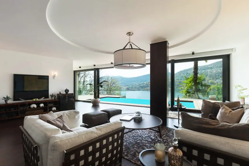 Living Room With Pool View And Circular Tray Ceiling