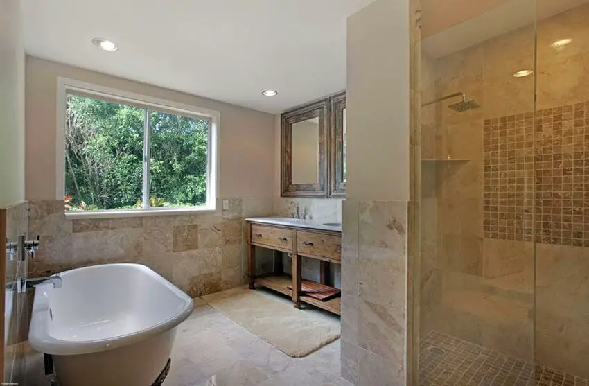 luxury master bathroom with rain shower and travertine tile with mosaic square insert