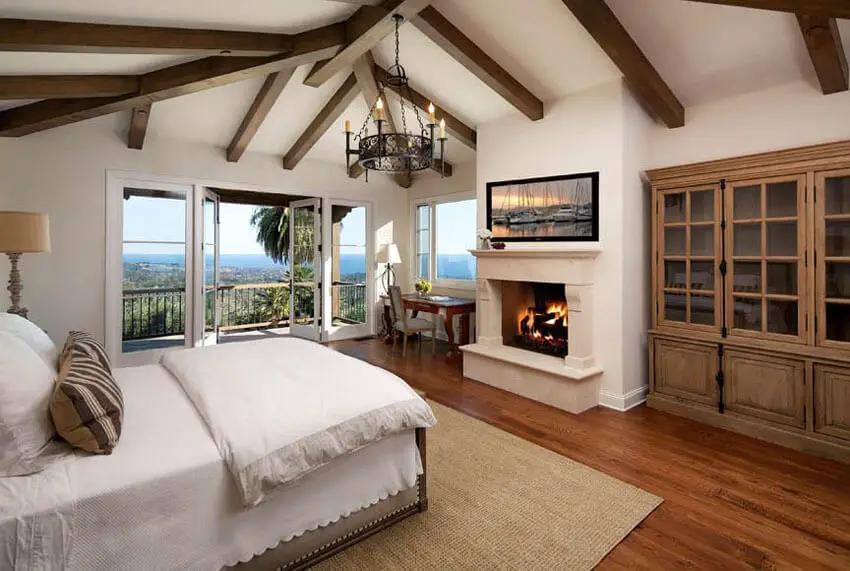 Mediterranean Style Master Bedroom Red Oak Flooring Chandelier and Balcony Views