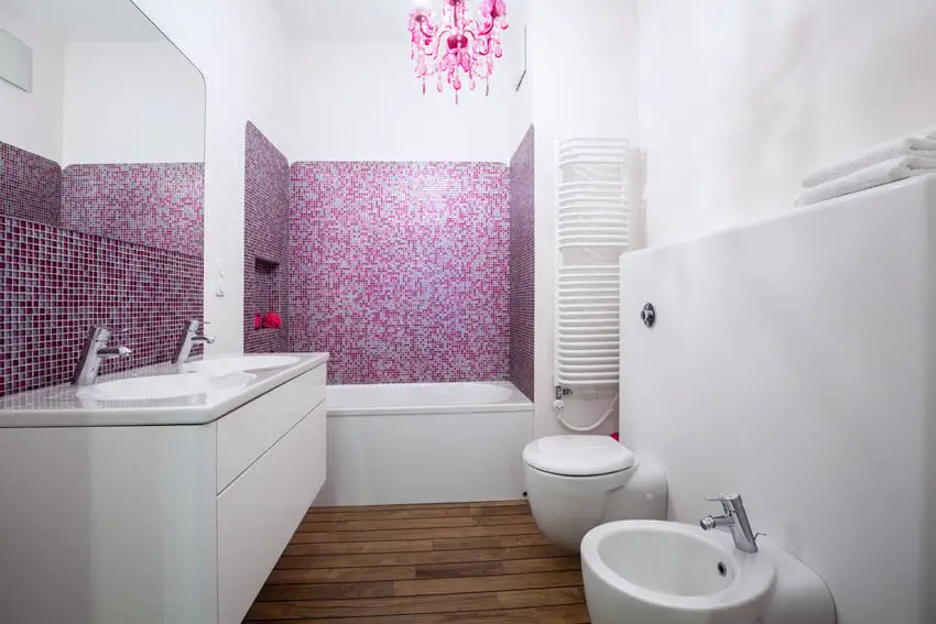 Modern bathroom with pink chandelier and mosaic tile