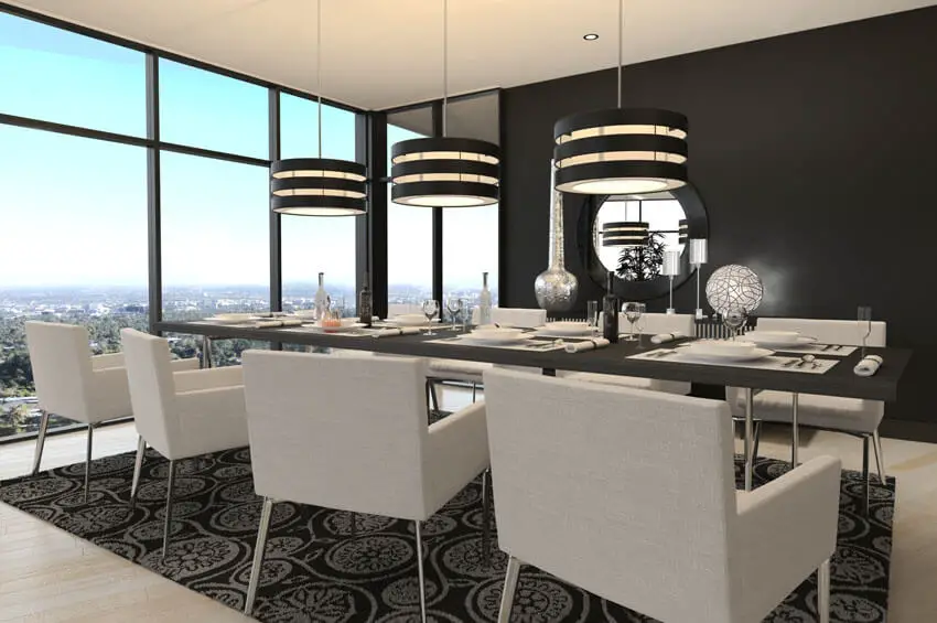 modern dining room with black accent wall and drum pendant lights