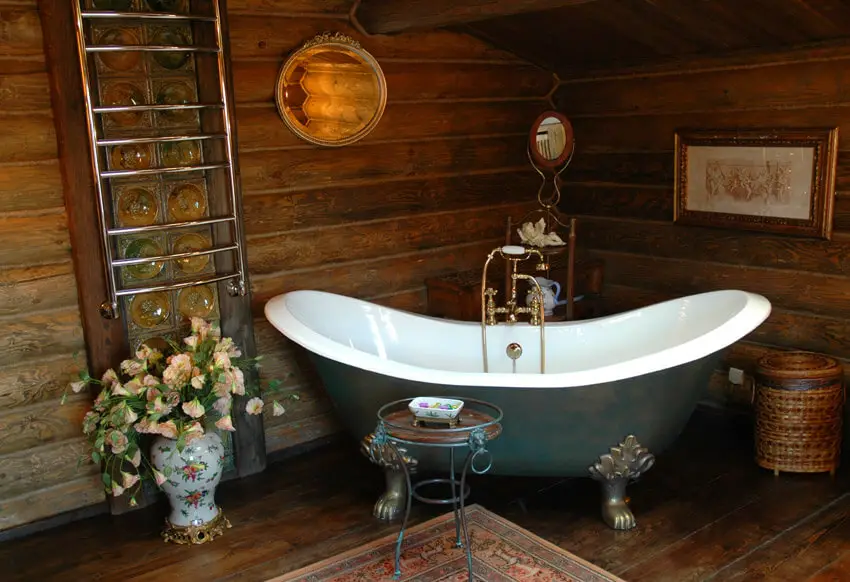 rustic bathroom in wood with claw foot bathtub