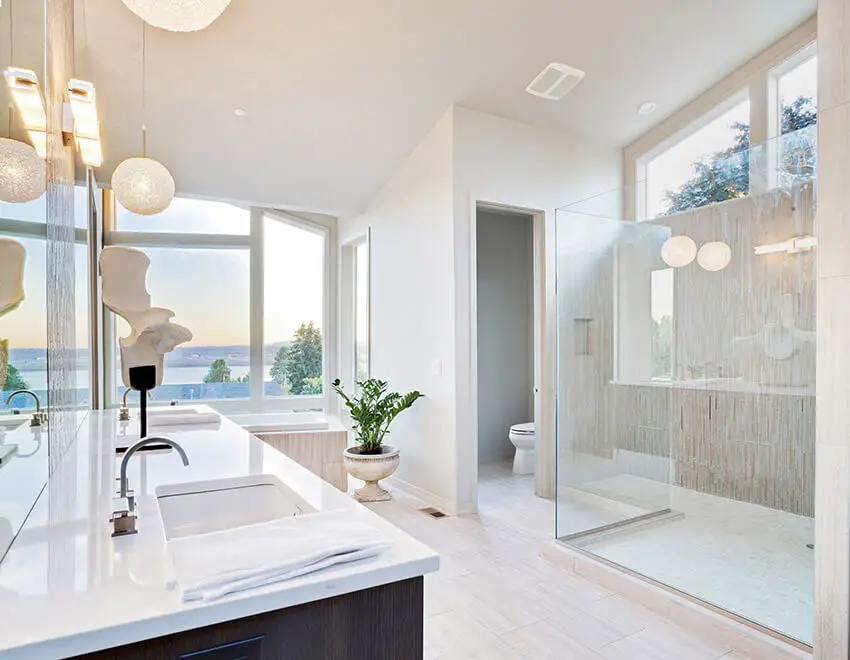 white bathroom with glass shower and globe lighting