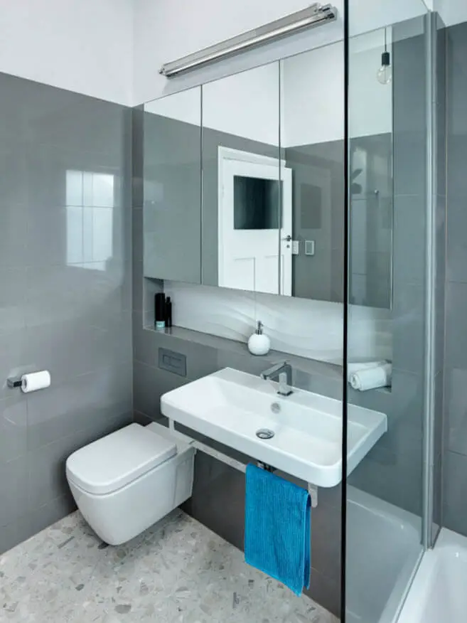 Small bathroom with gray ceramics and white toilets