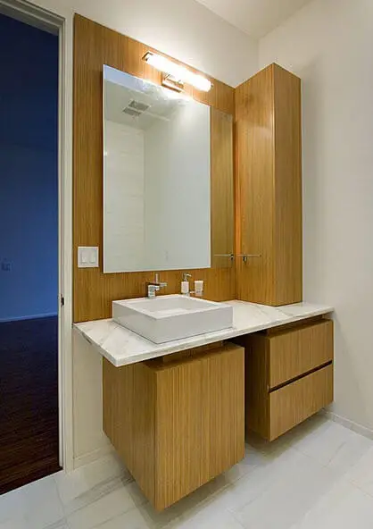 white bathroom sink and wood in the base design