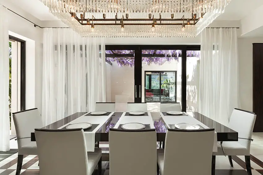 contemporary dining room with large linear chandelier