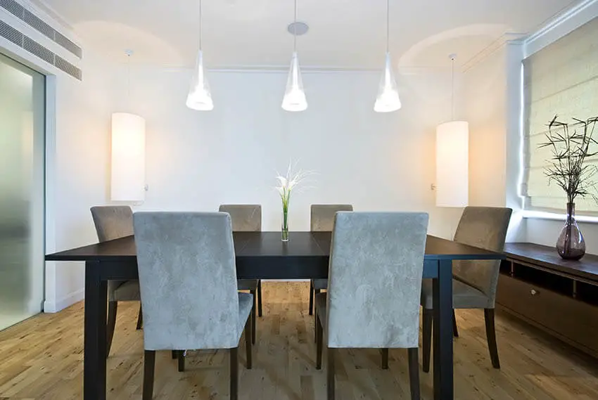 dining room with hanging pendant lights and corner lamps