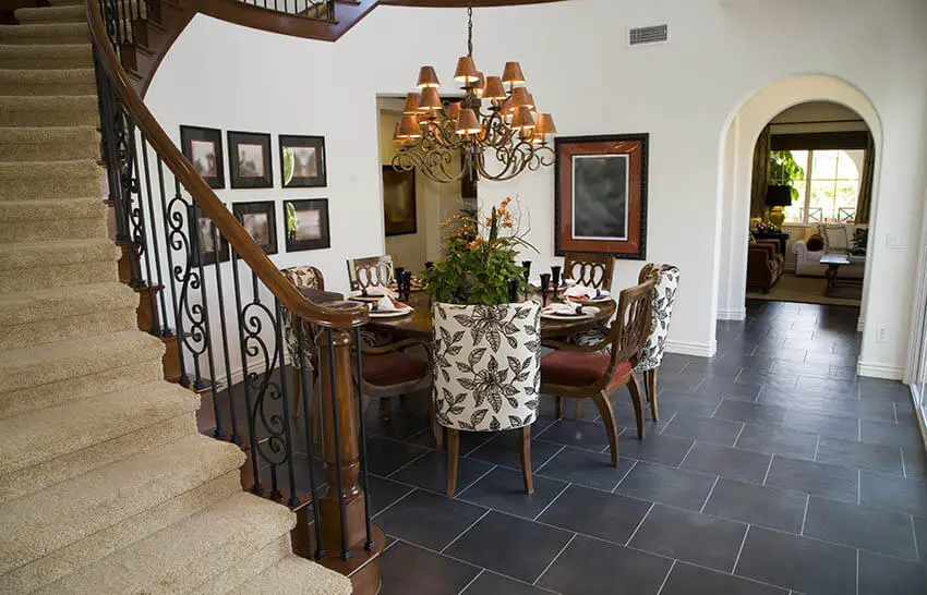 dining room with rustic chandelier and arched doorway